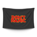 Bold ‘DON’T PANIC’ in big friendly letters on a moody dark backdrop — LoudBorders wall tapestry.