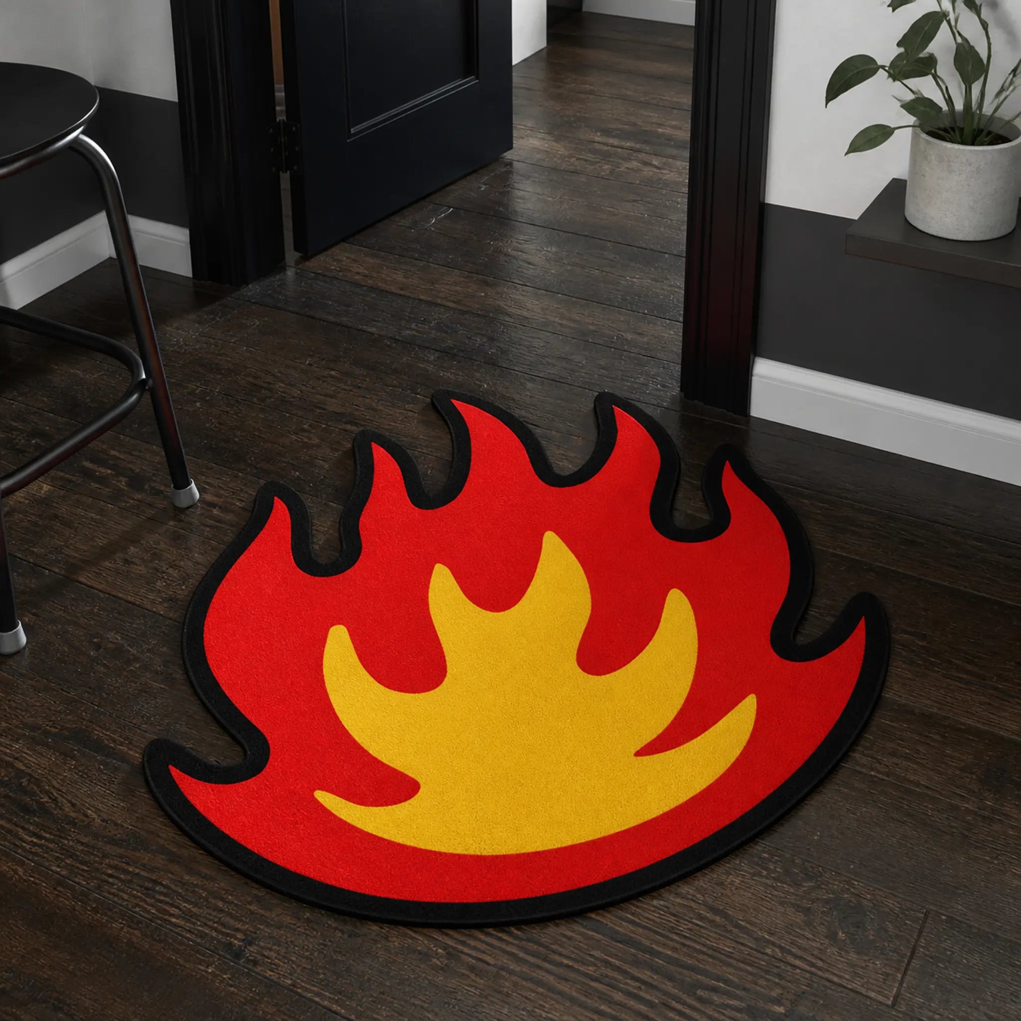 Flame Mode die-cut rug — red and yellow flame with black outline, cut to the flame silhouette with black edge binding