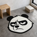 Grumpy Panda die-cut rug — black-and-white panda face mid-scowl with heavy brows and half-shut eyes, cut to the head shape with black edge binding