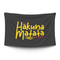 Bold ‘HAKUNA MATATA’ typographic statement in stark light type on a moody dark backdrop — LoudBorders wall tapestry.