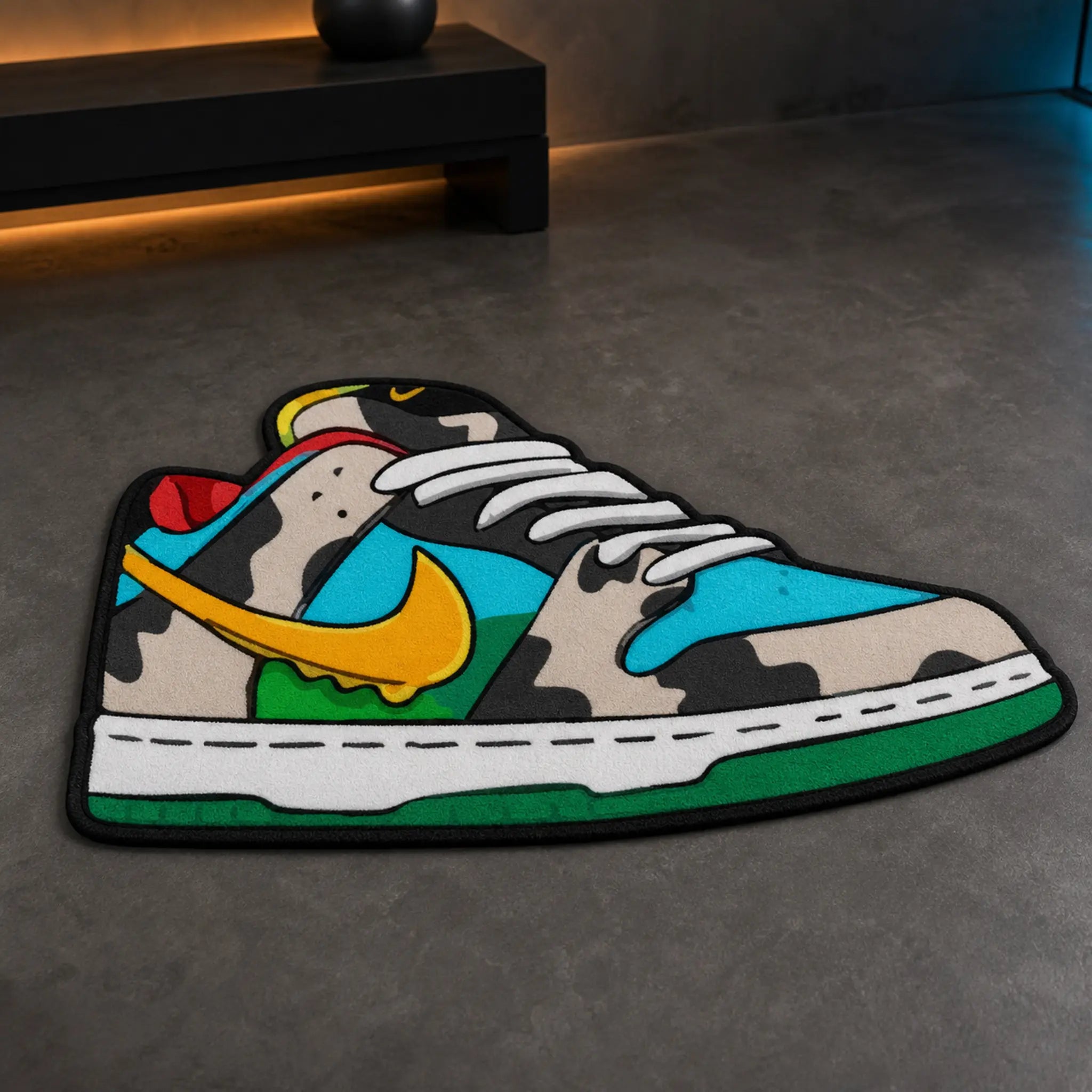Kickin’ It die-cut rug — low-top skate sneaker with cow-print panels, cyan overlays, yellow swoosh and green sole, cut to the shoe outline with black edge binding
