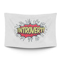 Bold ‘LOUD INTROVERT’ typographic statement in stark light type on a moody dark backdrop — LoudBorders wall tapestry.