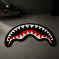 SAVAGE JAWS die-cut rug — shark mouth with white teeth over a red gum line on black, cut to the shape of the grin with black edge binding