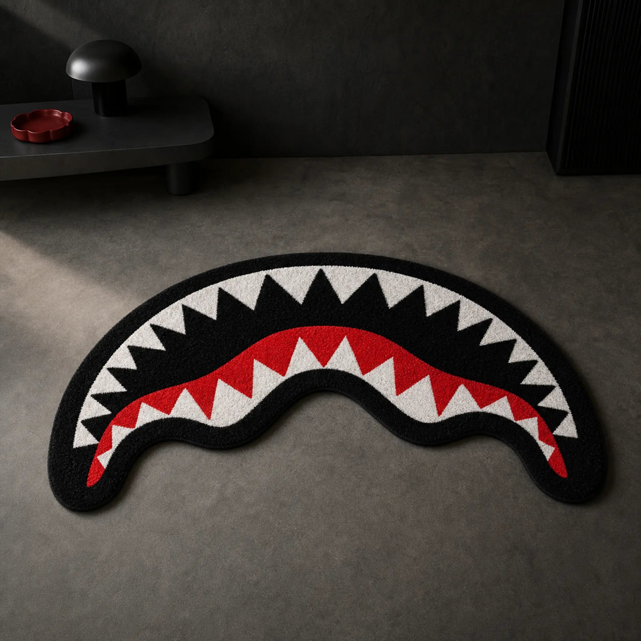 SAVAGE JAWS die-cut rug — shark mouth with white teeth over a red gum line on black, cut to the shape of the grin with black edge binding