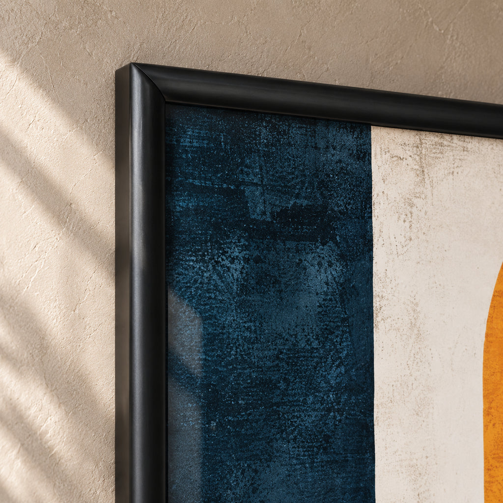 Top-left frame detail of The Ember Muse, showing the mitred corner and rounded satin-black profile beside the navy and ivory artwork.