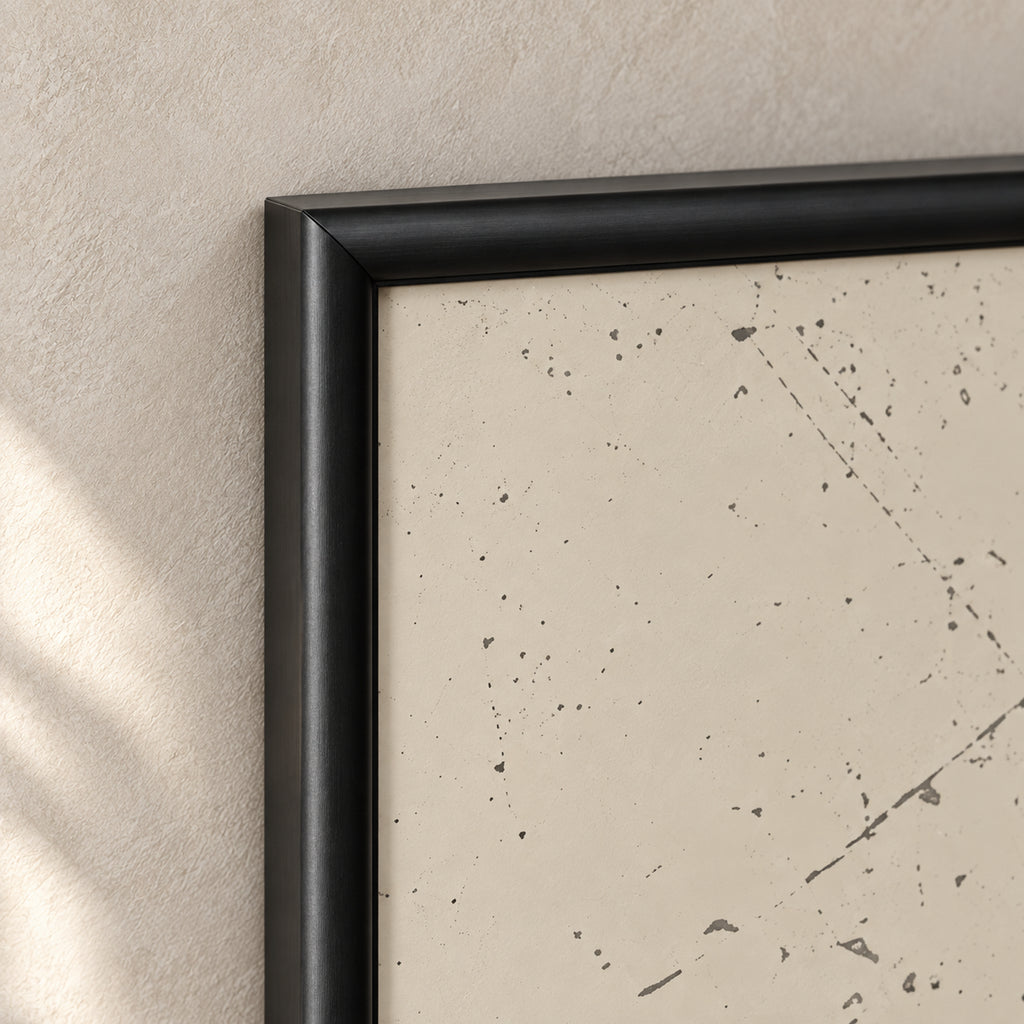 Bismillah Harmony frame detail showing a black mitered corner, gently rounded profile and adjacent ivory artwork with distressed markings.