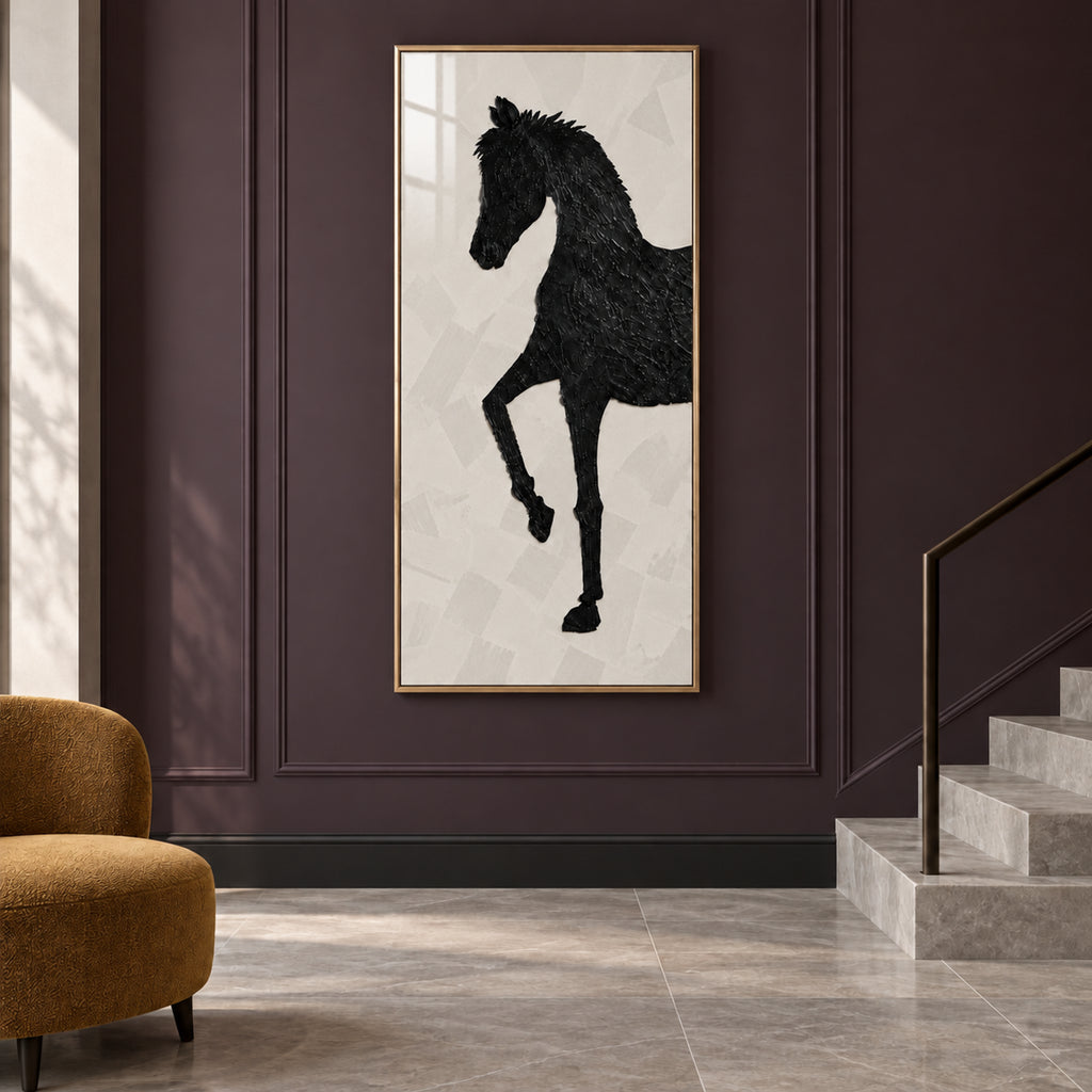 Front view of The Obsidian Stallion, a tall black-horse artwork in a gold frame beside a staircase and ochre chair.