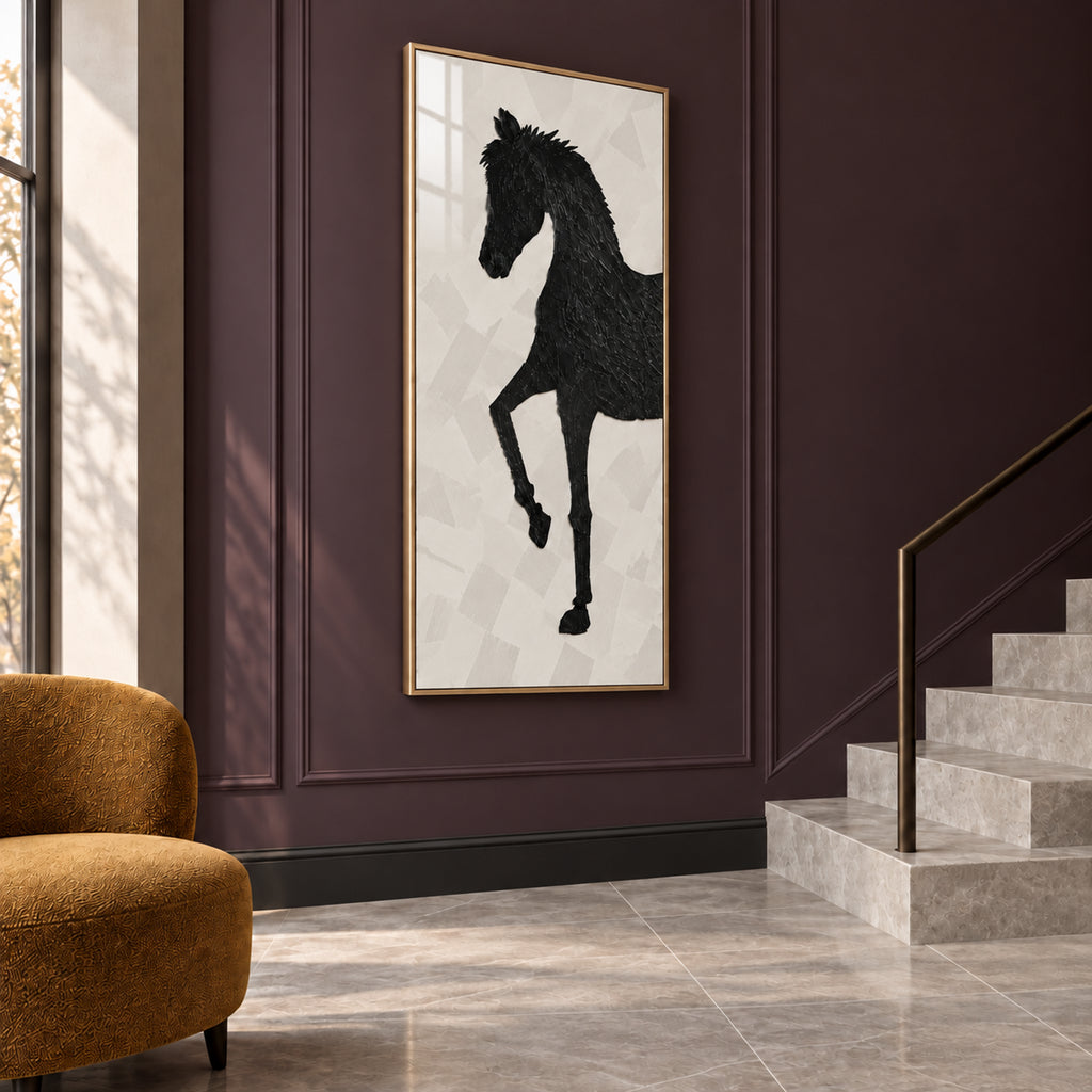 Angled view of The Obsidian Stallion showing the depth of its slim gold frame against a dark panelled wall.