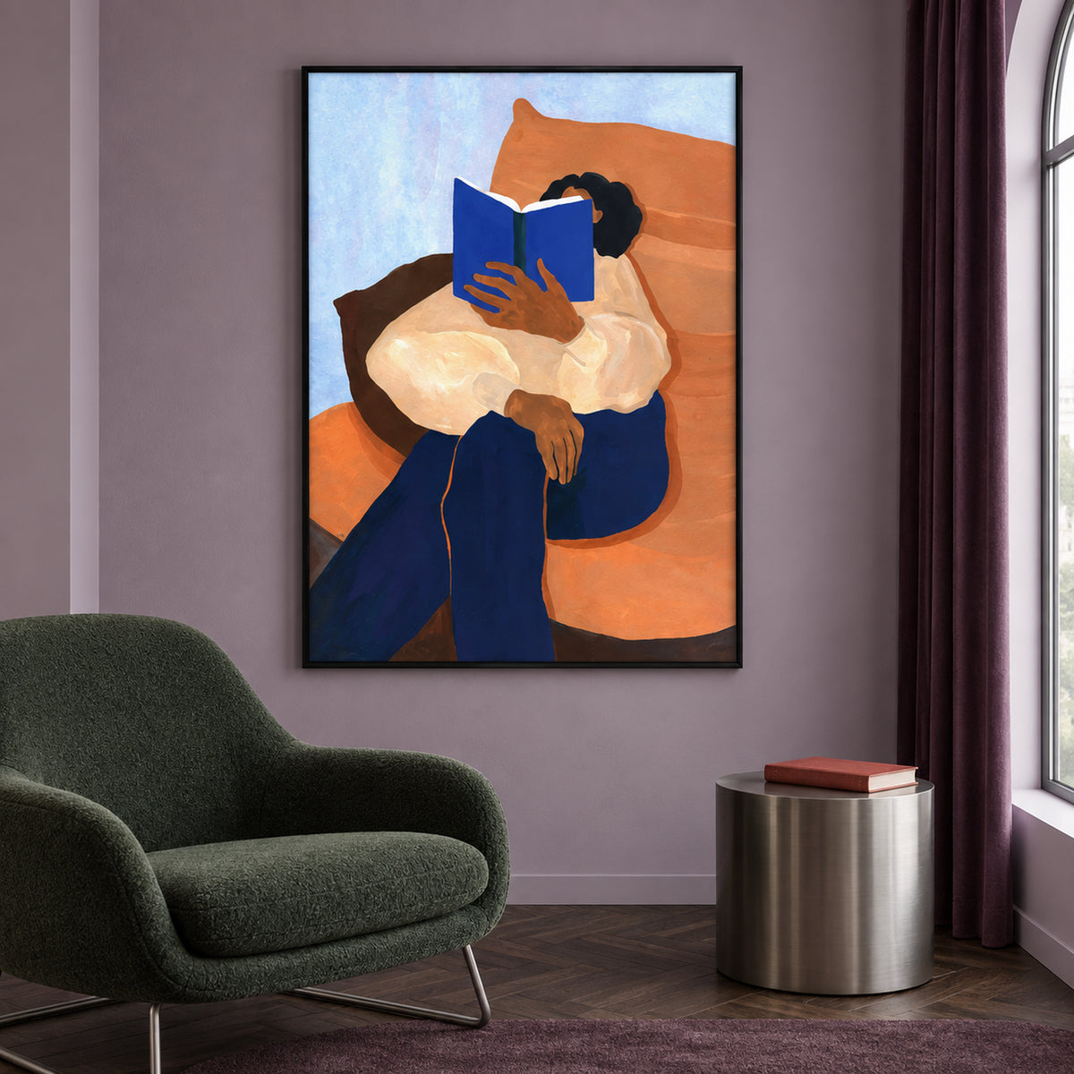 Front view of The Sunday Chapter: a reader with a blue book, cream blouse and blue trousers on an orange chair, in a slim black frame.