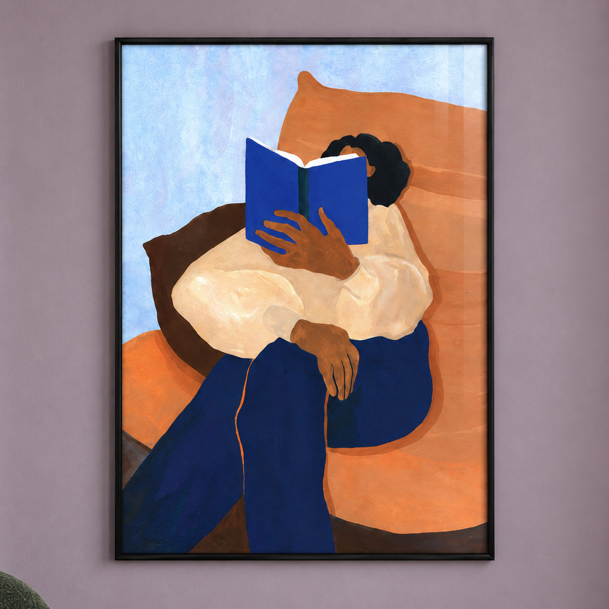 Close-up of The Sunday Chapter with a blue book hiding the reader's face, a cream blouse, orange chair and pale blue background within all four black frame edges.