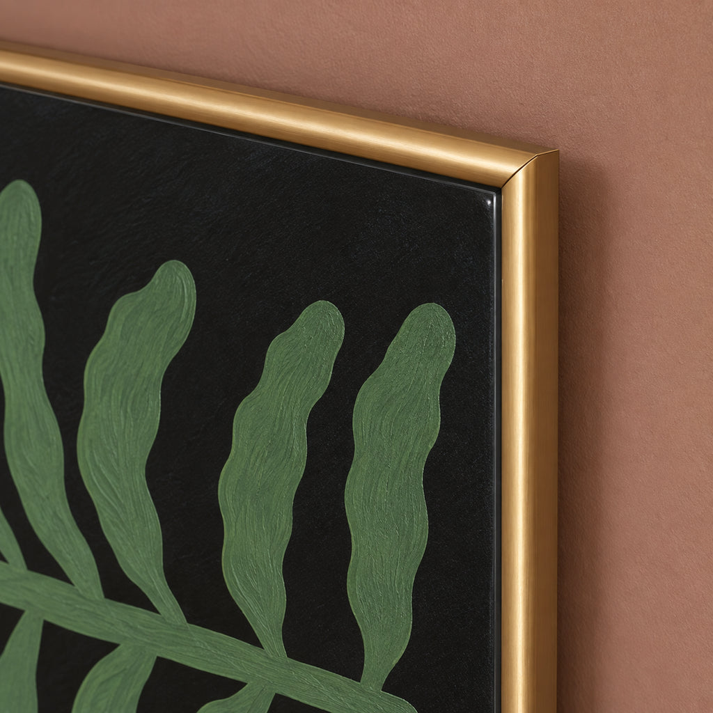 Fern & Ivory frame detail showing the gold corner beside textured green leaves and the black background.