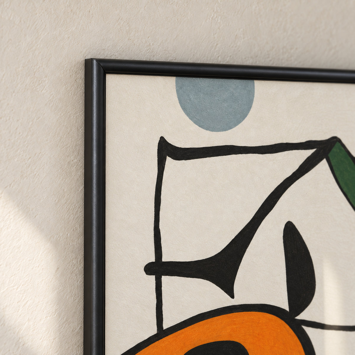 Chromatic Play frame detail showing the top-left mitred corner, rounded satin-black moulding and adjacent blue-grey, black and orange artwork.