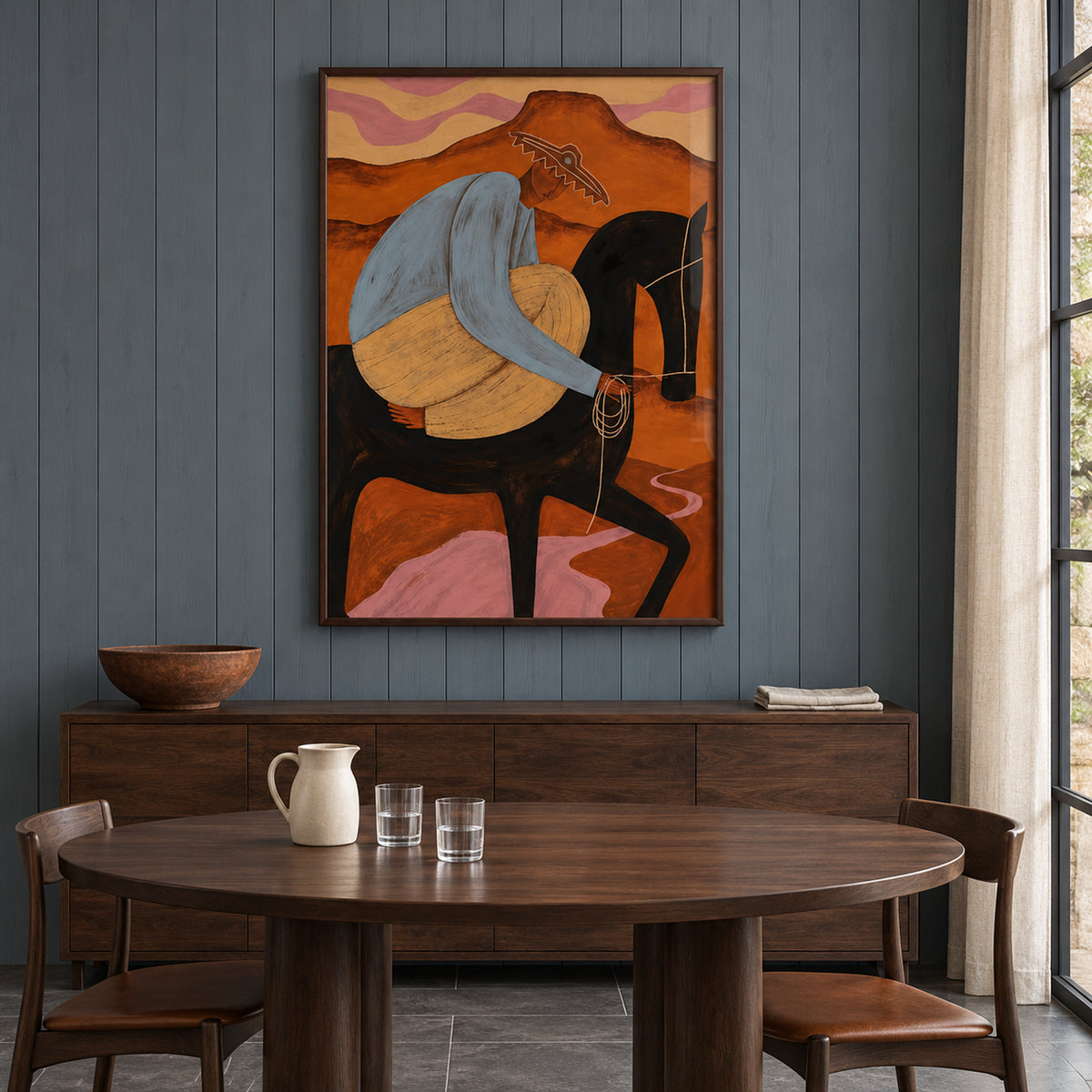 Front view of The Desert Rider, showing a rider in blue and ochre on a black horse against a rust-orange desert, in a dark brown frame.