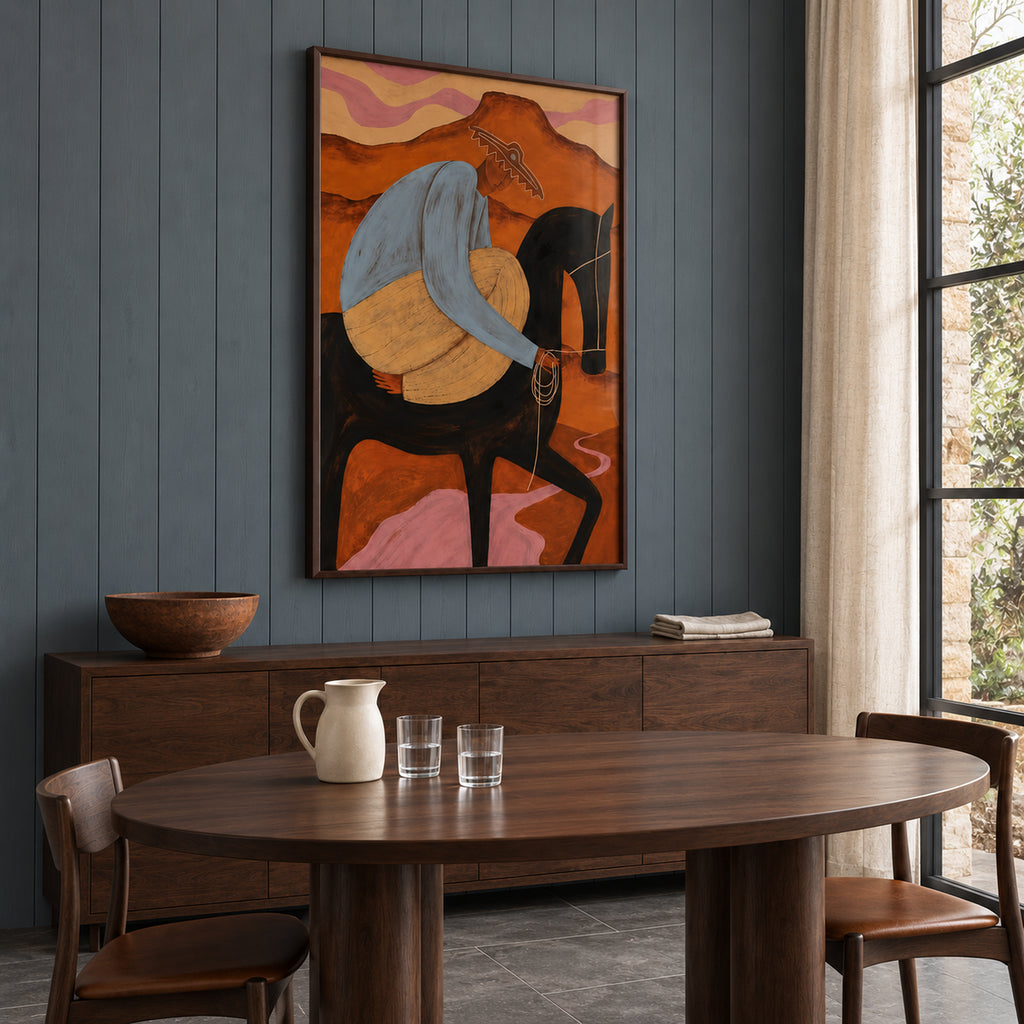 Angled view of The Desert Rider above a wooden sideboard, showing the portrait artwork and depth of its dark brown frame.