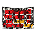 Inner Compass wall tapestry with red and amber maze typography reading Sometimes you need to get lost to find your way.