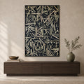 Front view of Midnight Script, gold-toned Arabic calligraphy on a near-black background in a thin black wooden frame above a walnut console.