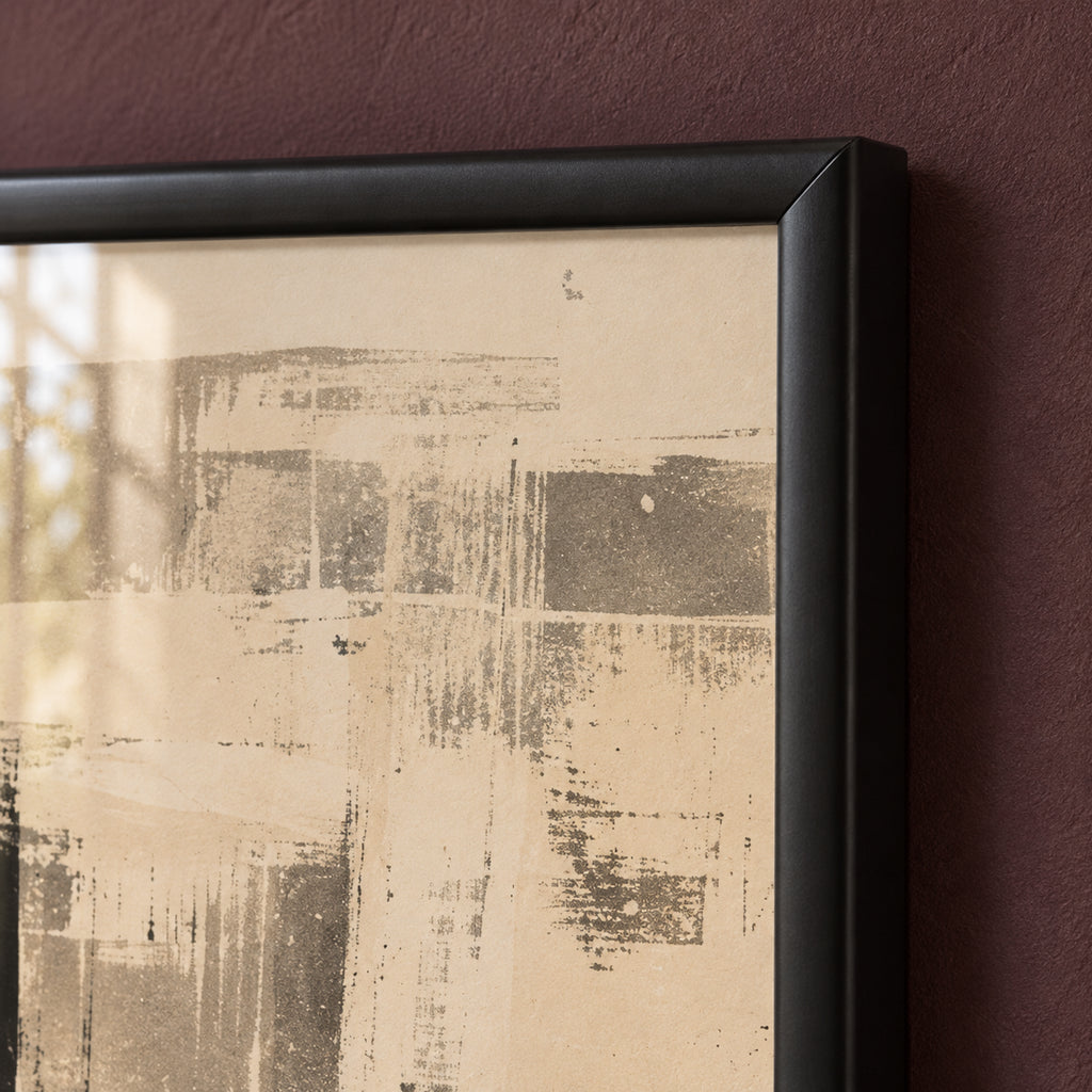 Frame detail of The Silent Minaret, showing the rounded black profile and mitred corner beside grey architectural marks on an ivory background.