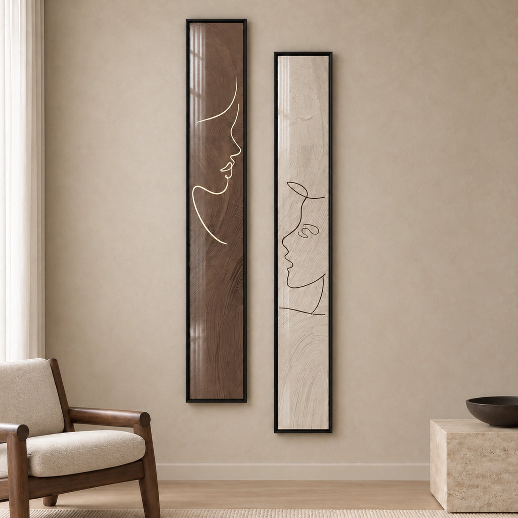 Closer front view of both Quiet Dialogue prints, showing the facing profiles, brown and ivory palette, and complete black frames.