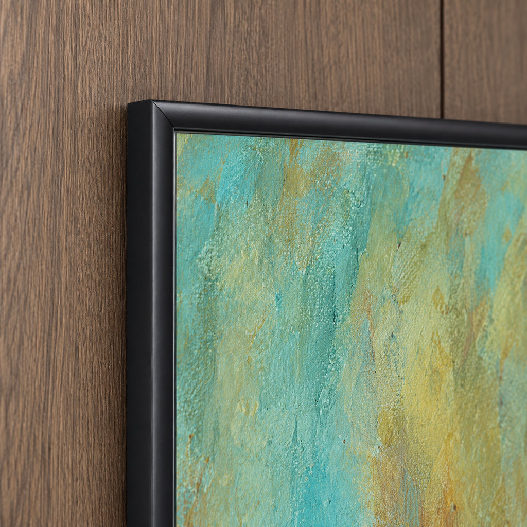 Frame detail of Between Us showing the black wooden corner and softly blended turquoise and yellow artwork.