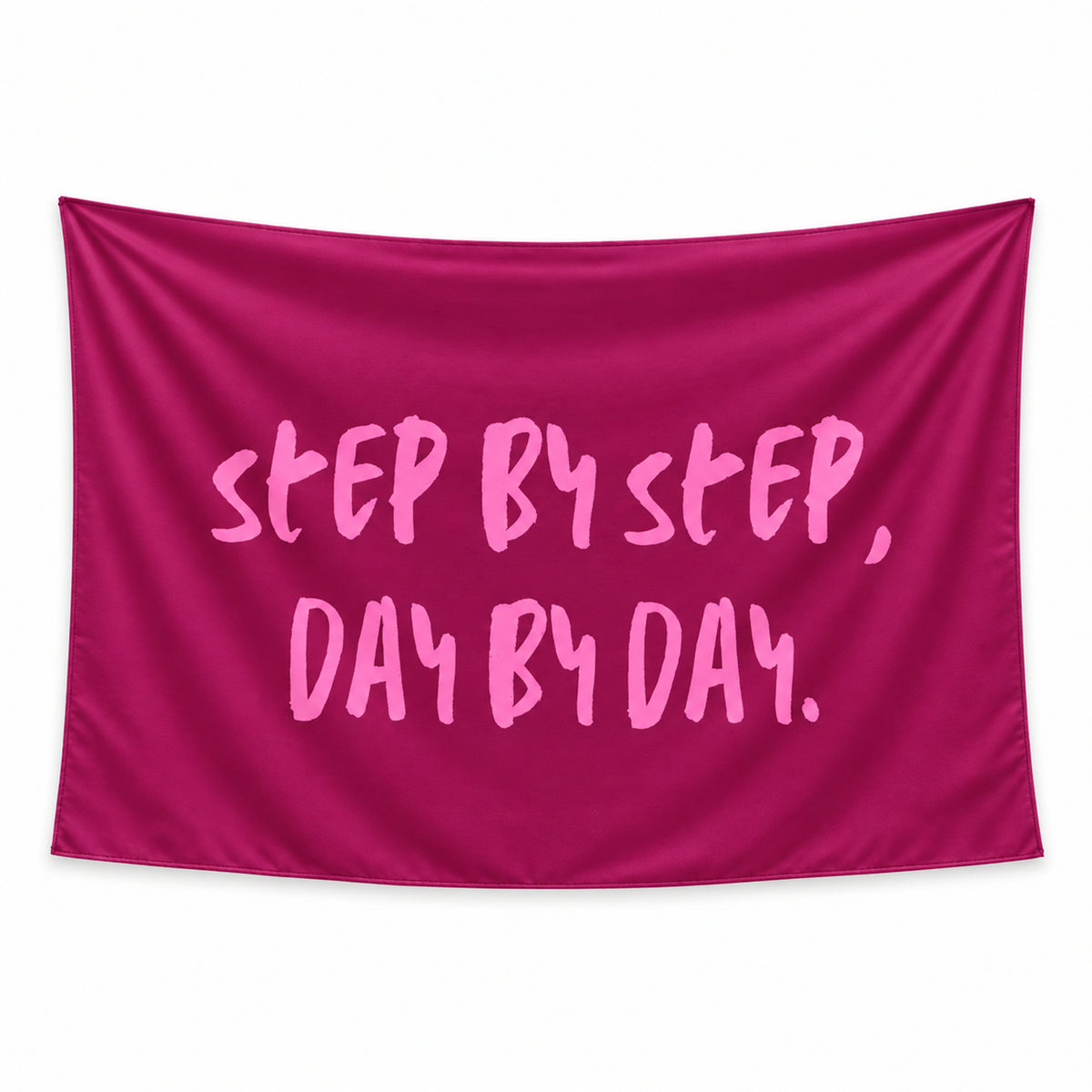 Steady Progress wall tapestry with STEP BY STEP, DAY BY DAY in light pink brush lettering on a deep berry background.