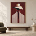 Front view of The Burgundy Muse: a burgundy fashion portrait with an ivory hat and pinstriped jacket in a thin gold frame above a walnut bench.