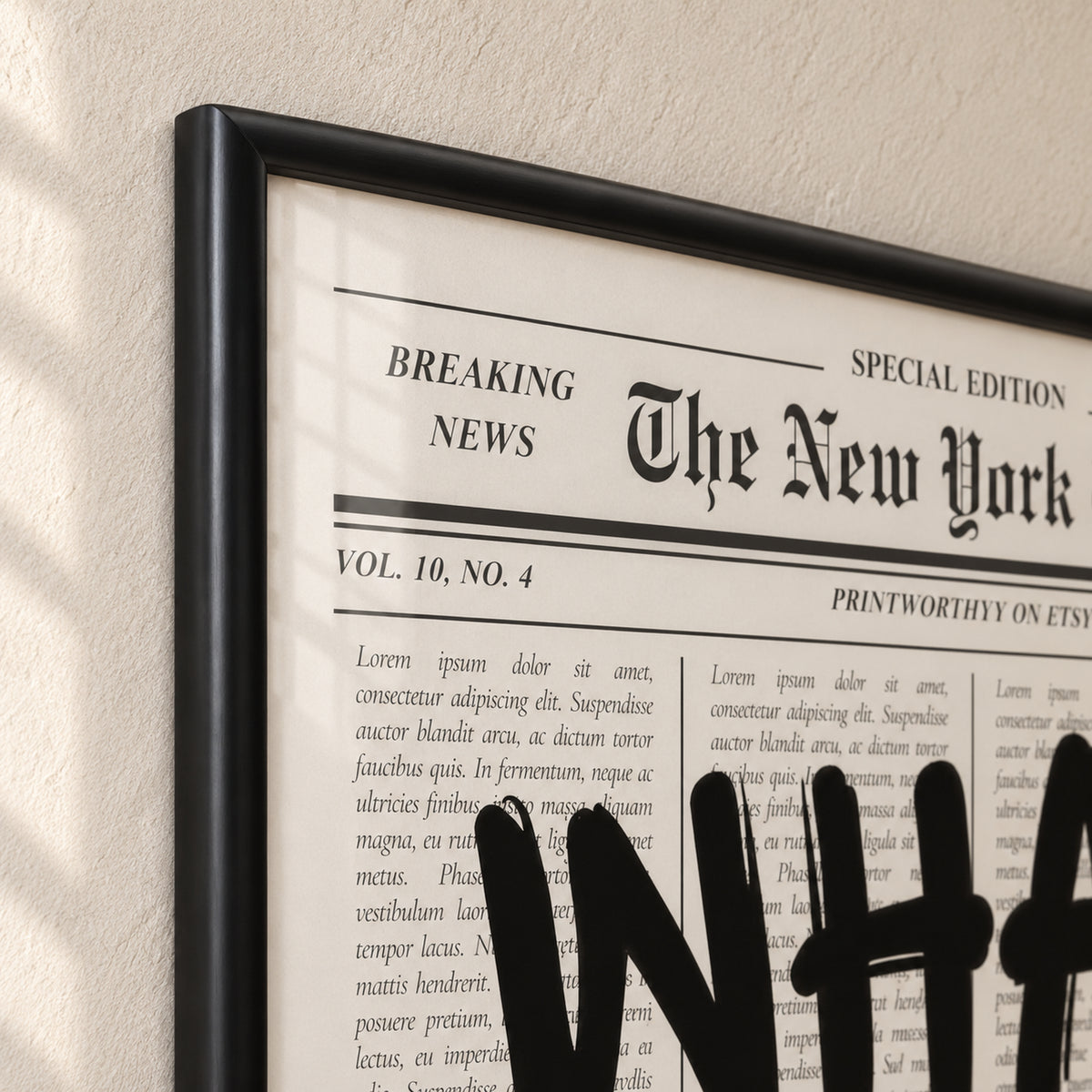 Top-left corner of The Optimist’s Edition frame, showing the mitred joint, rounded satin-black molding and adjacent newspaper print behind glass.